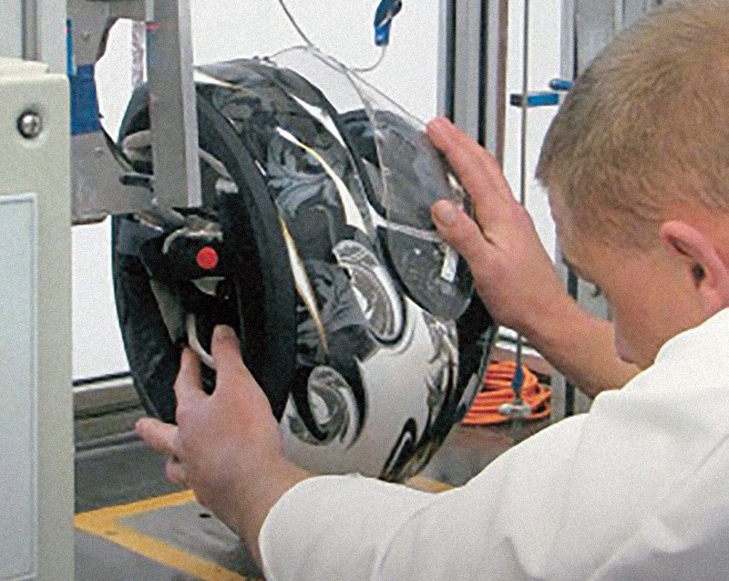 Motorcycle helmet being tested by a whitecoat